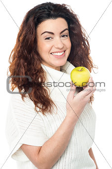 Joyous woman with an apple in hand