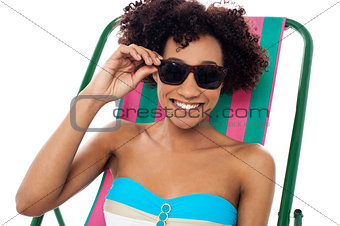 Relaxing female model adjusting her shades