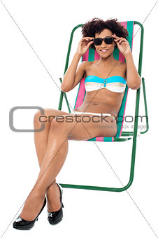 Fashion lingerie model relaxing on deckchair