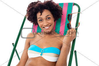 Glamorous woman in lingerie relaxing on a deckchair
