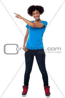 Attractive young woman pointing sideways