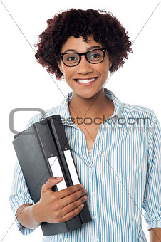 Bespectacled woman in casuals holding files