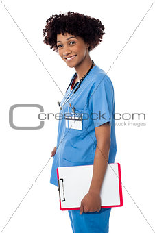 Smiling medical professional holding blank clipboard