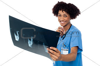 Attractive young medical professional holding x-ray sheet