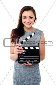 Attractive woman with clapperboard