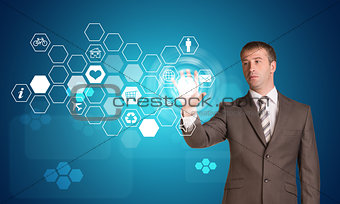 Businessman pressing virtual icons
