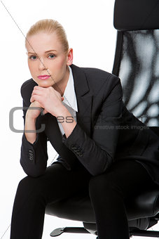 businesswoman with hands below chin