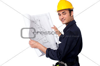 Construction worker reviewing blueprint