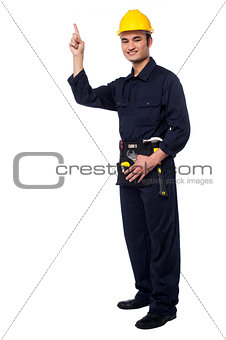 Construction worker pointing upwards