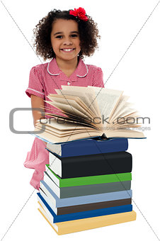 Portrait of pretty schoolgirl reading textbook