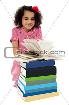 Active kid reading a book and learning