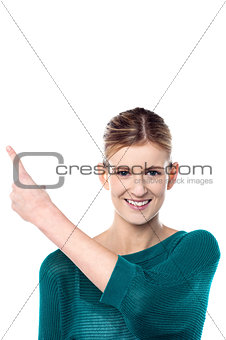 Charming female model pointing away