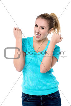Excited charming girl with clenched fists