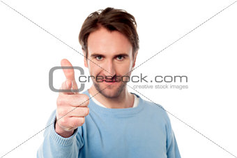Young man pointing towards you