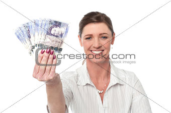 Business woman holding fan of currency notes