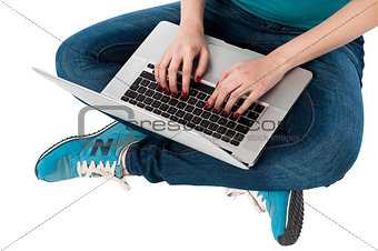 Cropped image of a girl working on laptop
