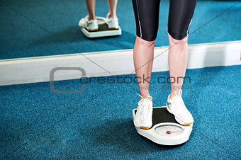Cropped image of a woman measuring weight