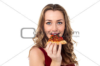 Young female having yummy pizza