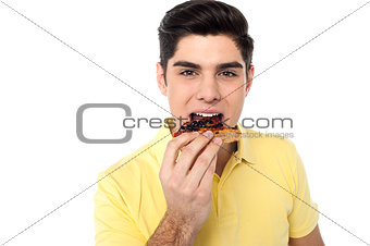 Handsome guy enjoying yummy pizza