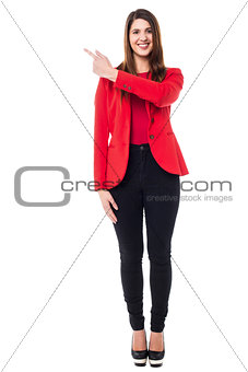 Pretty caucasian woman pointing backwards