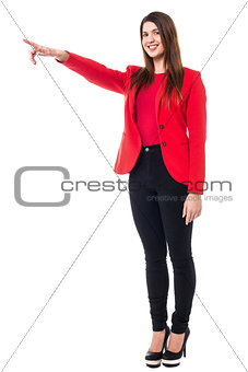 Charming young woman pointing away