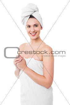 Hot woman in bath towel smiling at you