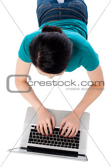 Aerial shot of a girl working on laptop