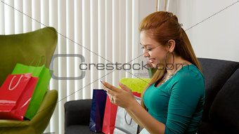 Latina Girl With Shopping Bags Typing On Mobile Phone 