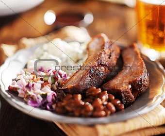 barbecued spare rib meal with beer and fixings like baked beans, cole slaw, and potato salad