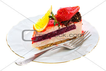 Piece of cake with a fresh strawberry and orange.