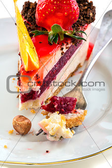Plate of cake with fresh strawberries and orange.