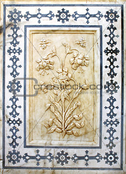 Ancient carved flower on marble in Amber Fort, Jaipur, Rajasthan