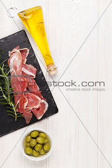 Prosciutto with rosemary, olives and olive oil