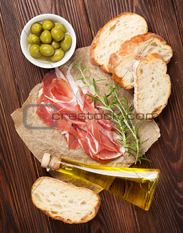 Bruschetta ingredients - prosciutto, olives and olive oil