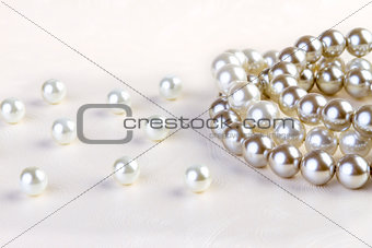 Silver and White pearls necklace on white paper 