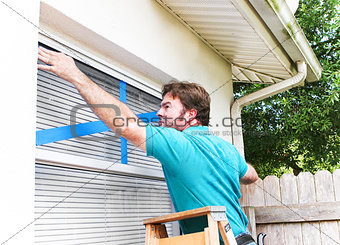 Man Taping His Windows