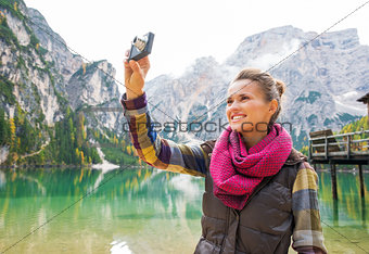 Woman on the shores of Lake Bries taking a photo of the scenery
