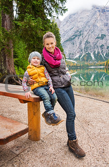 Mother and daughter resting at wooden picnic table on Lake Bries