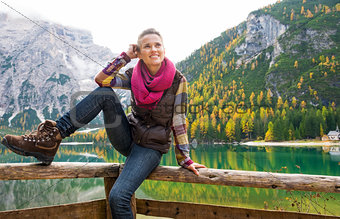 Smiling woman hiker posing at Lake Bries with autumn colours