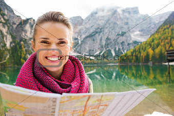 Portrait of smiling brunette at Lake Bries holding map