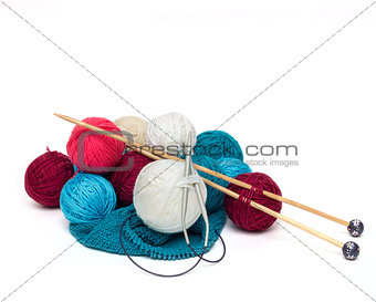 colorful balls of wool with needles