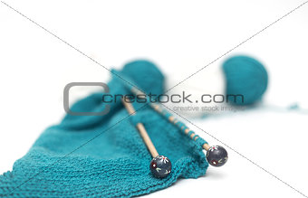 blue yarn knitted fabric, knitting spokes close-up