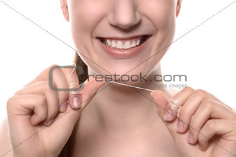 Woman with healthy white teeth with dental floss