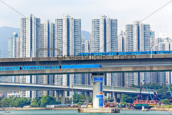 high speed train on bridge in hong kong downtown city