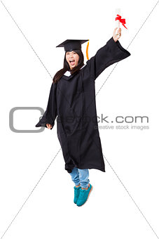 Happy  student in graduate robe jumping isolated on white