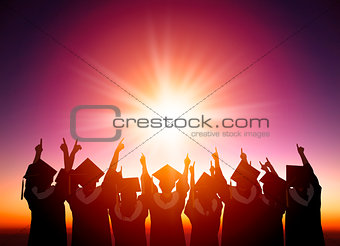 silhouette of Students Celebrating Graduation watching the sunli