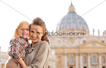 Smiling mother and daughter cheek to cheek in Vatican City Rome