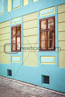 Blue house facade with wooden windows from Sighisoara city old c