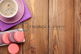 Colorful macaron cookies and cup of coffee