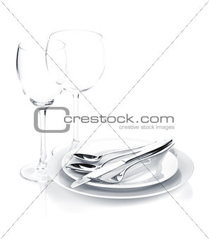 Silverware or flatware set over plates and wine glasses